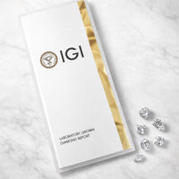 IGI laboratory grown diamond report with diamonds on a marble surface