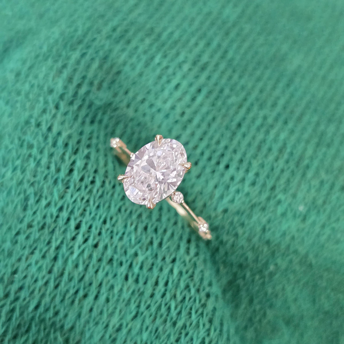 Diamond ring on a textured green surface